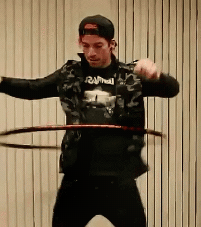 Man In Black Rammell Shirt Spinning Hula Hoop GIF