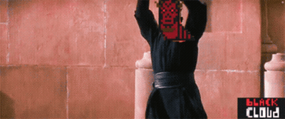 Man In Black Robe In Front Of Pink Wall GIF