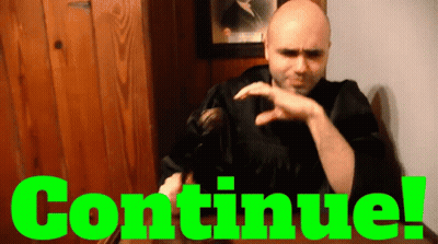Man In Black Robe Sitting In Front Of Continue Sign GIF