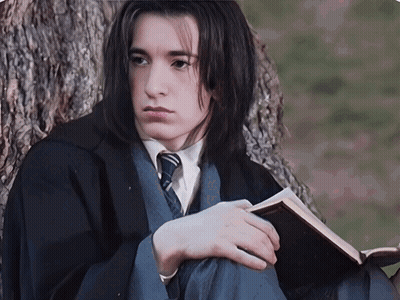 Man In Black Robe Standing In Front Of Window GIF