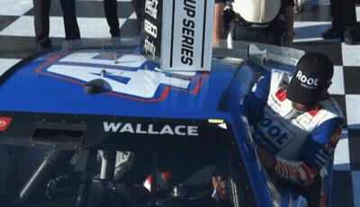 Man In Black Root Hat In Front Of Race Car GIF