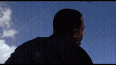 Man In Black Shirt Against Blue Sky Clouds GIF