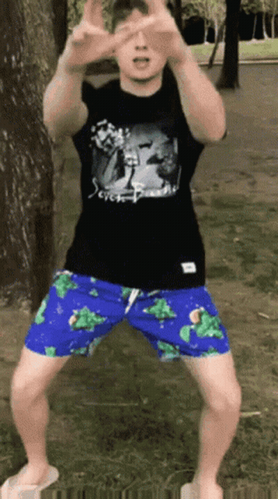 Man In Black Shirt And Blue Shorts In Park GIF