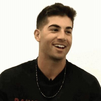 Man In Black Shirt And Chain Smiling GIF
