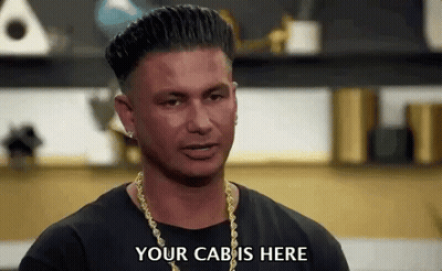 Man In Black Shirt And Gold Chains Saying Your Cab Is Here GIF