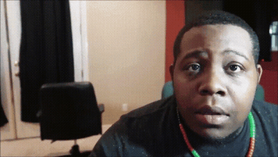 Man In Black Shirt And Green Red Necklace GIF