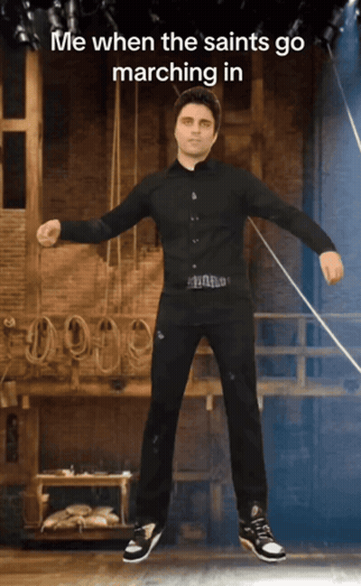 Man In Black Shirt And Pants On Stage Saying Me When The Saints Go Marching GIF