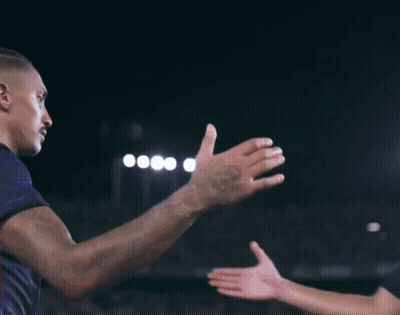 Man In Black Shirt And Purple Shorts Kneeling On Soccer Field GIF