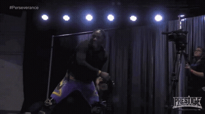 Man In Black Shirt And Purple Shorts With Prestige Camera GIF