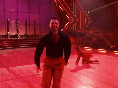 Man In Black Shirt And Red Pants Dancing On Stage GIF