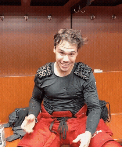 Man In Black Shirt And Red Pants Sitting GIF
