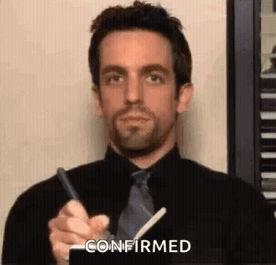 Man In Black Shirt And Tie Holding Pen GIF