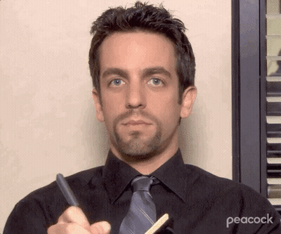 Man In Black Shirt And Tie Holding Pen And Pencil GIF
