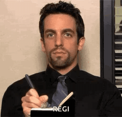 Man In Black Shirt And Tie Holding Pen Notepad GIF