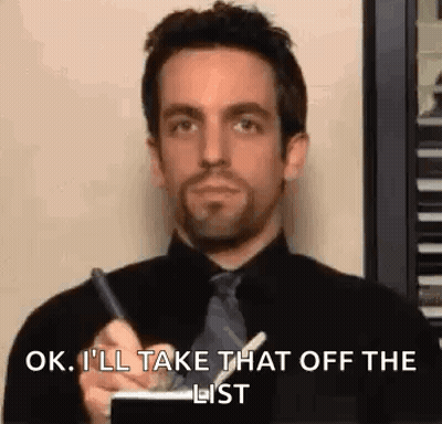 Man In Black Shirt And Tie Writing On Notepad GIF