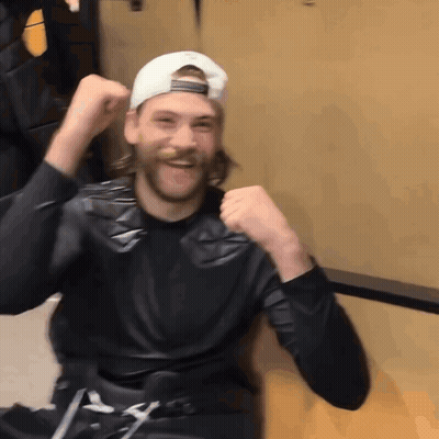 Man In Black Shirt And White Hat Raising Fist GIF