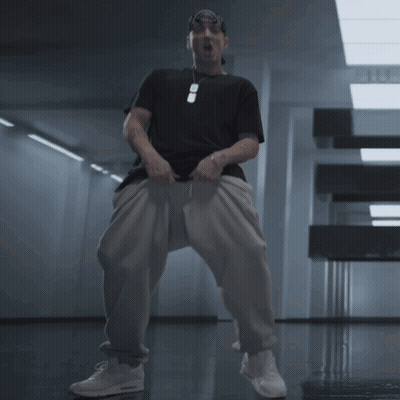 Man In Black Shirt And White Pants In Hallway GIF