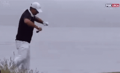 Man In Black Shirt And White Pants Kneeling With Golf Club GIF