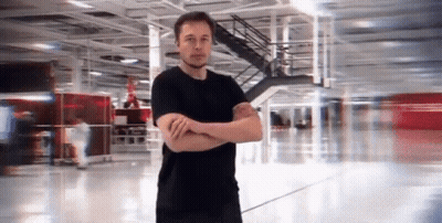 Man In Black Shirt Arms Crossed In Empty Building GIF
