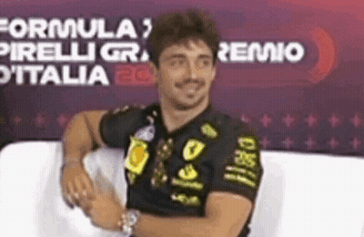 Man In Black Shirt Arms Crossed Smiling On Couch GIF