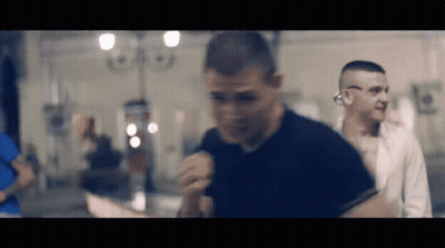 Man In Black Shirt Before Crowd In Dark Room GIF