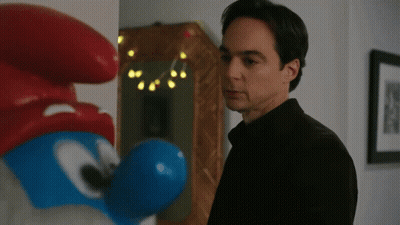 Man In Black Shirt Beside Smurf Statue GIF