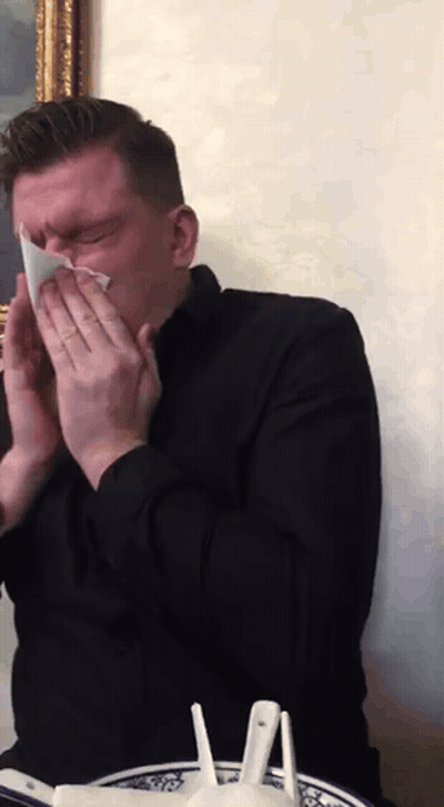Man In Black Shirt Blowing His Nose GIF