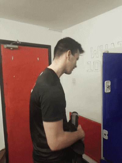Man In Black Shirt By Wall With Number 10 GIF