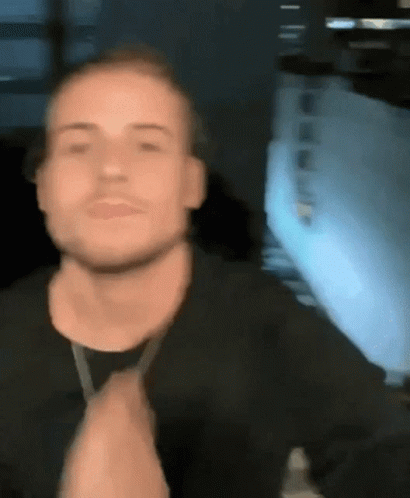 Man In Black Shirt Clapping In Front Of Window GIF