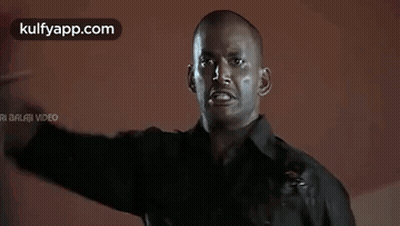 Man In Black Shirt Covering Eyes With Blood On Face GIF