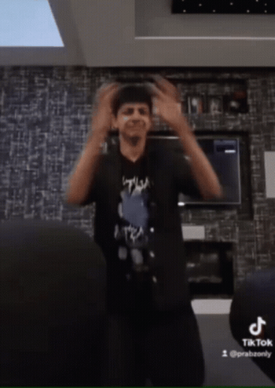 Man In Black Shirt Dancing By TikTok Logo GIF