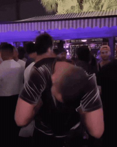 Man In Black Shirt Dancing In Crowd At Party GIF