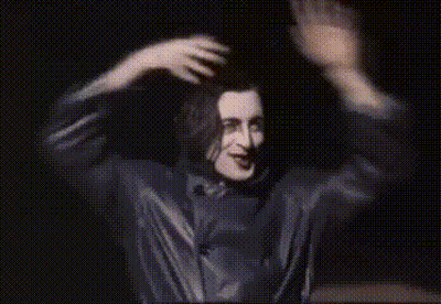 Man In Black Shirt Dancing In Dark Room GIF