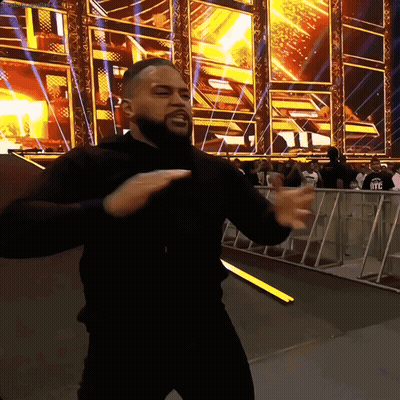 Man In Black Shirt Dancing In Front Of WWE Sign GIF