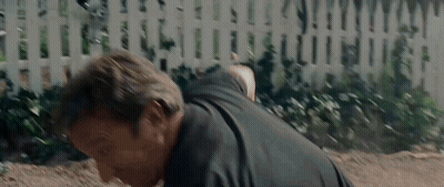 Man In Black Shirt Doing Push Ups In Front Of White Picket Fence GIF