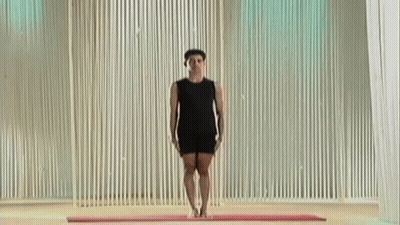 Man In Black Shirt Doing Yoga Pose On Mat GIF