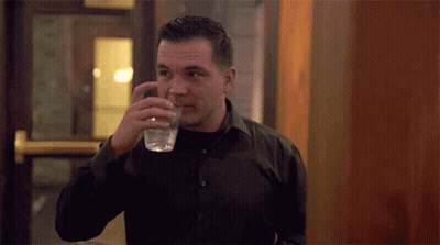 Man In Black Shirt Drinking From Glass GIF