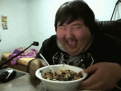 Man In Black Shirt Eating Bowl With Tongue Out GIF