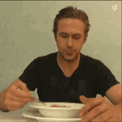 Man In Black Shirt Eating From Bowl With Spoon GIF