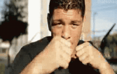 Man In Black Shirt Fist To Mouth GIF