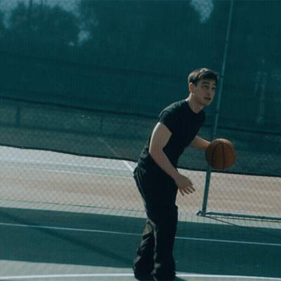 Man In Black Shirt Holding Basketball Over Head GIF