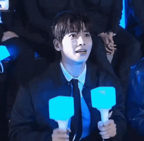 Man In Black Shirt Holding Blue Light Stick GIF