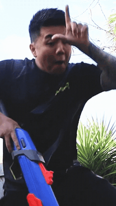 Man In Black Shirt Holding Blue Water Gun GIF