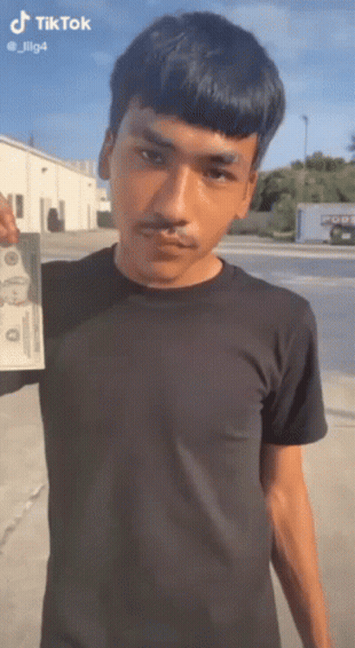 Man In Black Shirt Holding Dollar Bill GIF