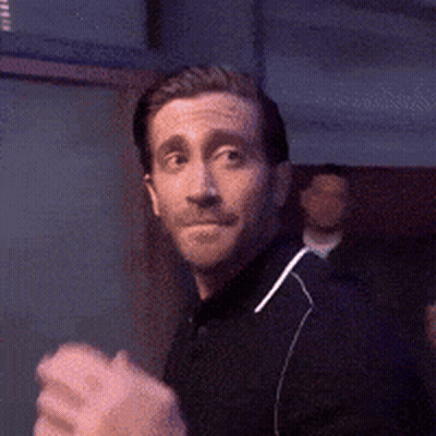 Man In Black Shirt Holding Fist Up GIF