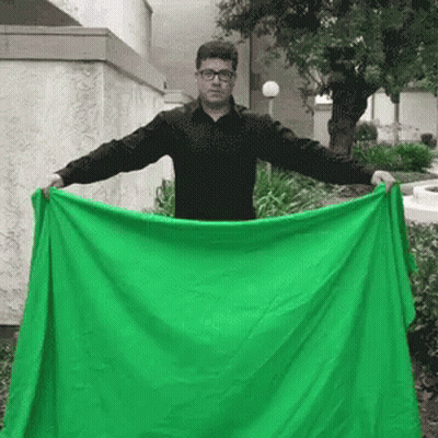 Man In Black Shirt Holding Green Blanket GIF