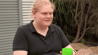 Man In Black Shirt Holding Green Cup GIF