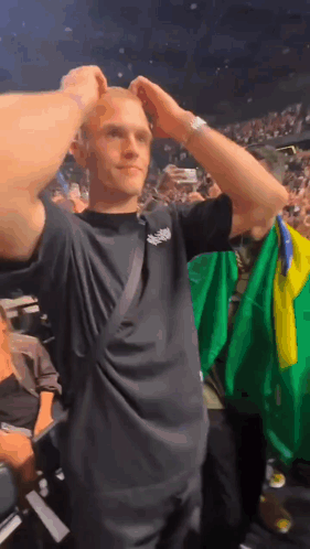 Man In Black Shirt Holding Green Yellow Flag GIF