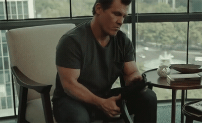 Man In Black Shirt Holding Gun GIF