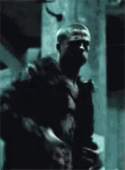 Man In Black Shirt Holding Gun GIF